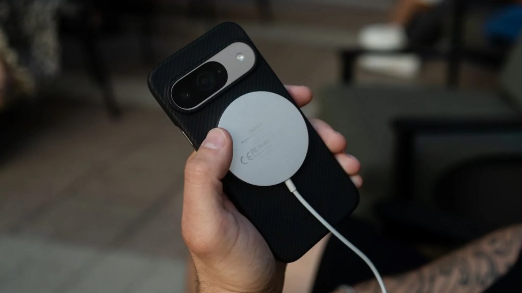 Google Pixel 10 smartphone charging on a Qi2 magnetic wireless charging stand