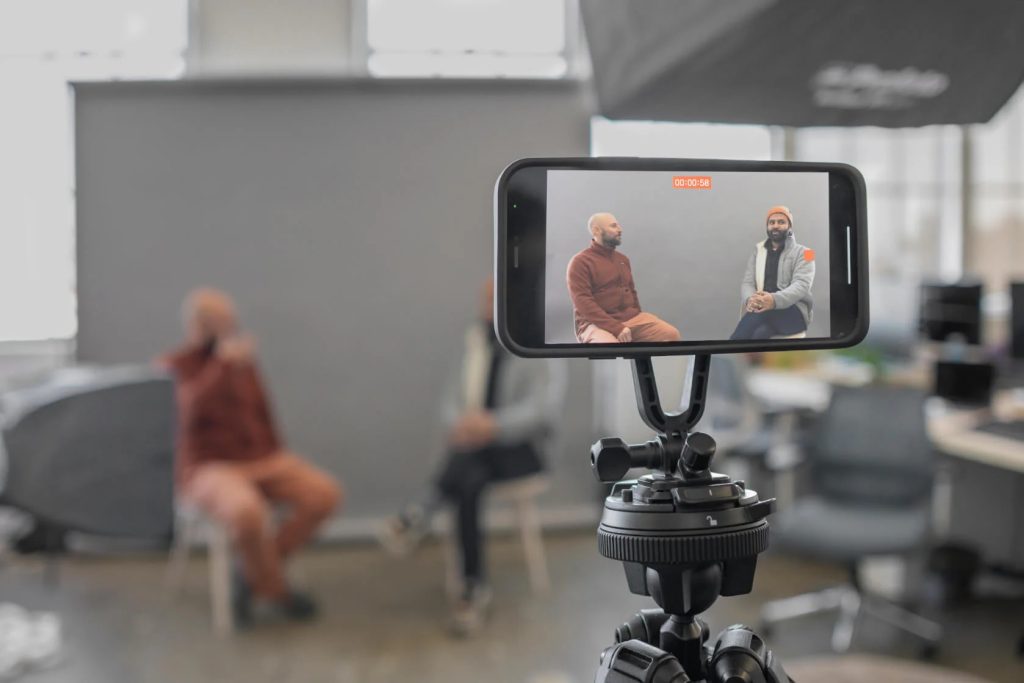 Content creator recording video using a smartphone in 2025