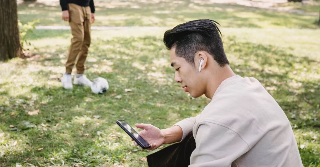 User enjoying quiet moment with best noise cancelling earbuds 2025 in a busy urban environment