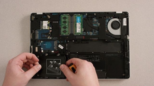 Laptop opened to show internal repair components
